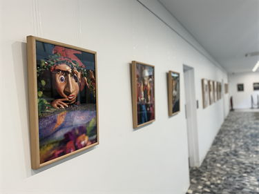 Wall of photos and puppets in cabinet from Celebrating the Art of Puppetry Atrium Exhibition