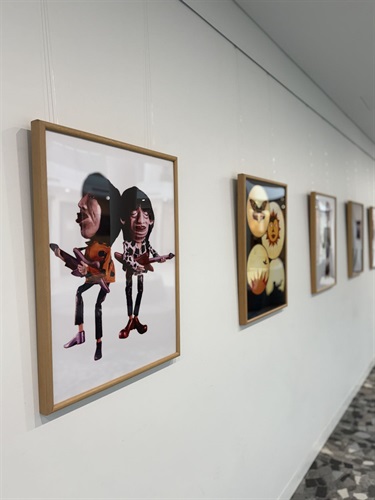 Wall of photos and puppets in cabinet from Celebrating the Art of Puppetry Atrium Exhibition