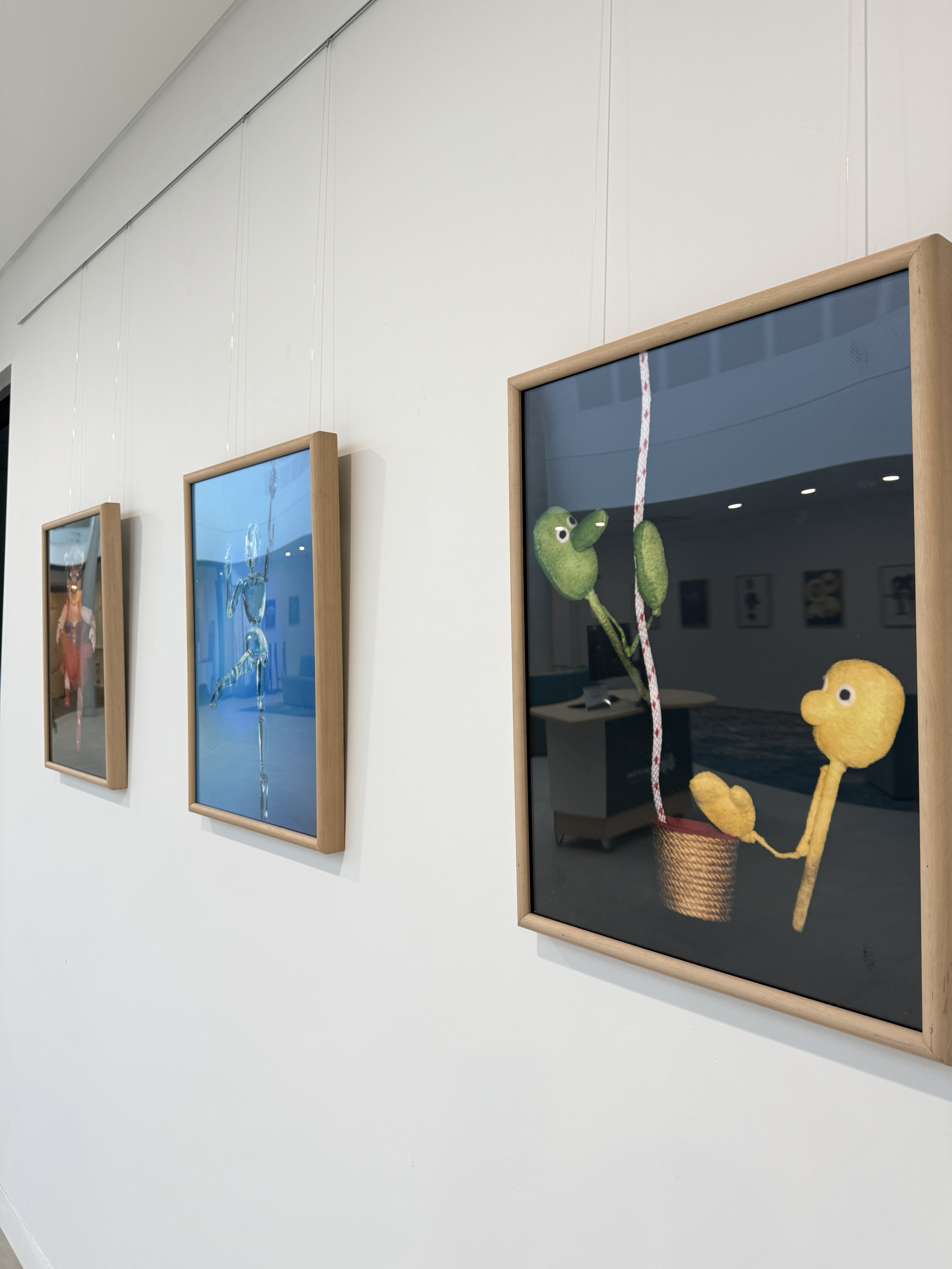 Wall of photos and puppets in cabinet from Celebrating the Art of Puppetry Atrium Exhibition