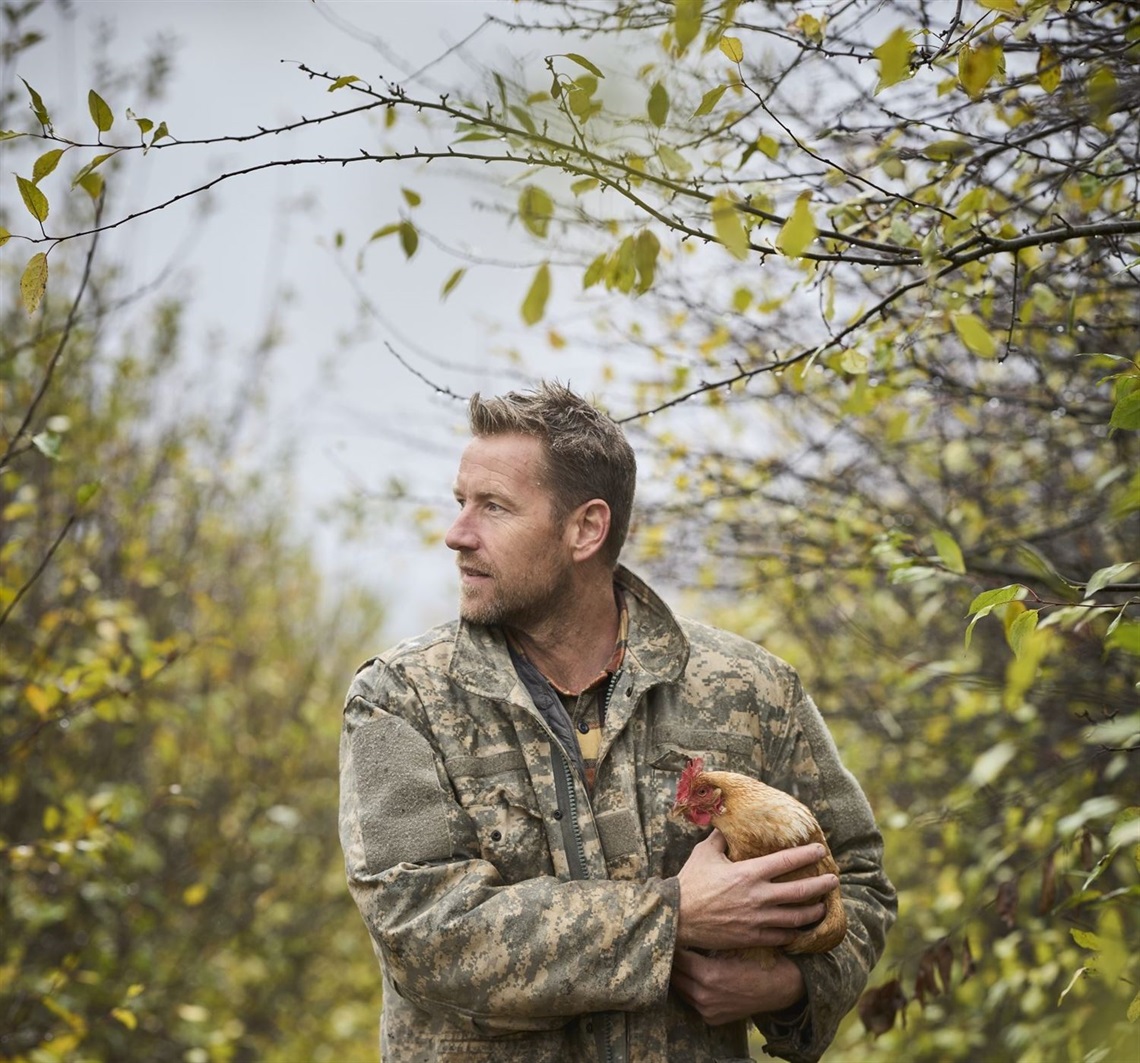 A person holding a chicken