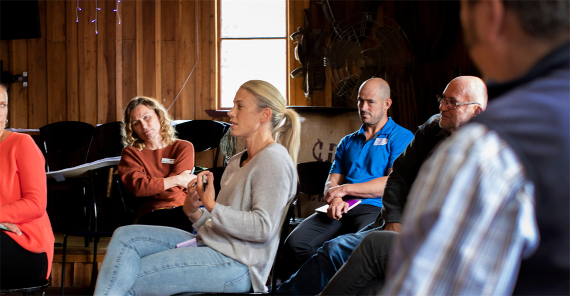 Picture of a council staff member talking to a group of community members