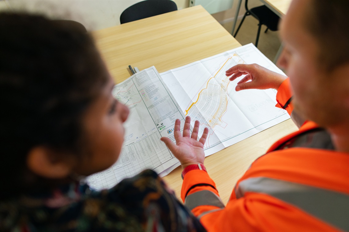 Two people looking at plans