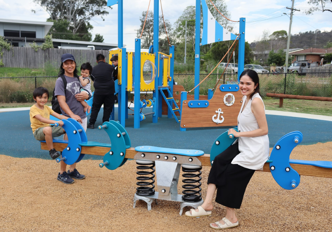 Children and parent enjoying playspace equipment at Cook Street