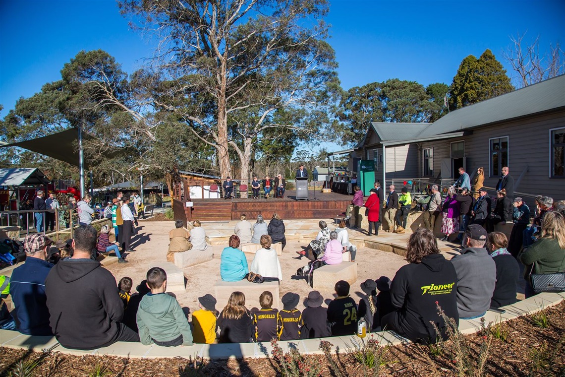 Attendees to Casburn Park opening sitting around the pit listening to speeches