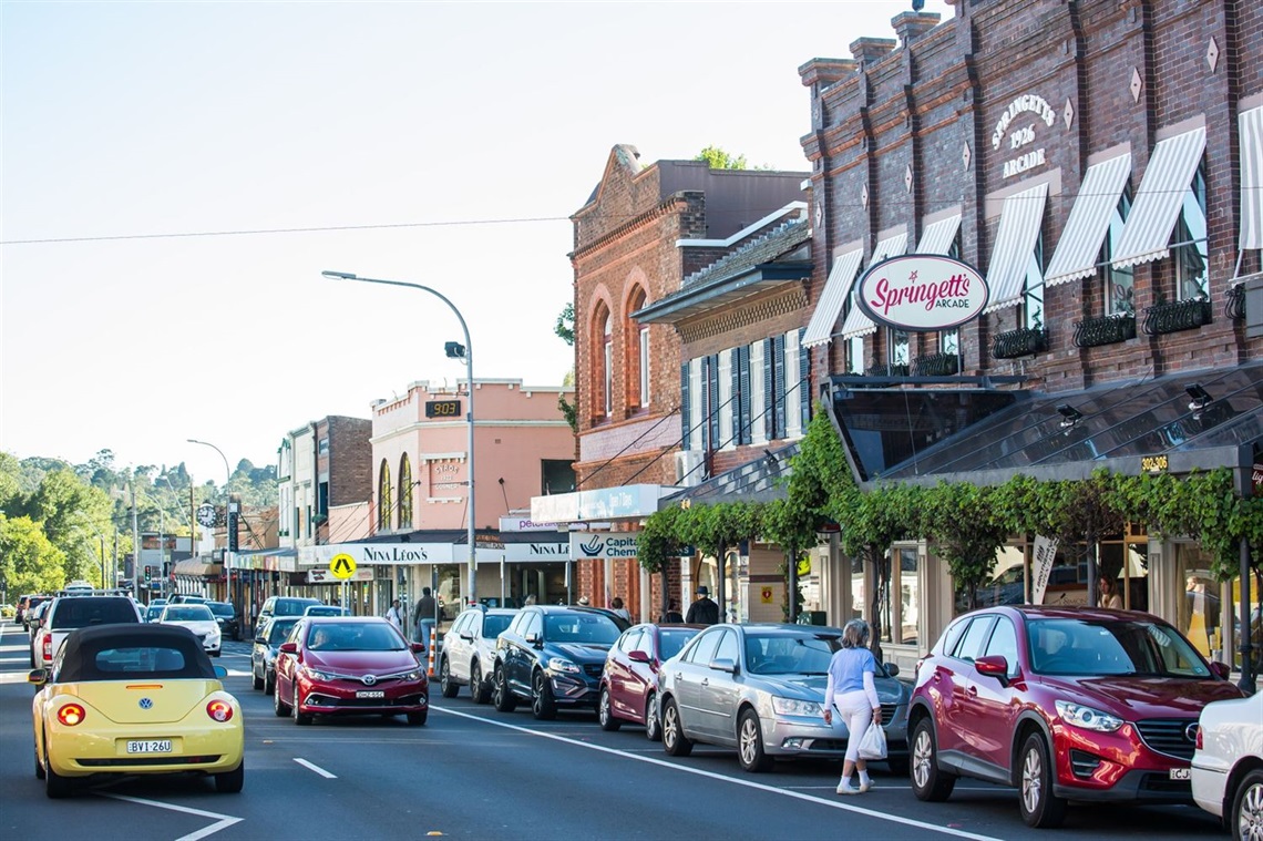 Bong Bong St, with cars parked on either side of the road