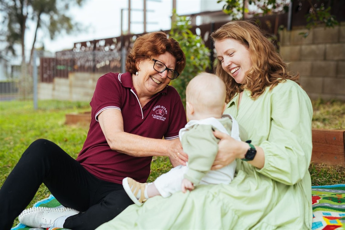 mother and baby with a volunteer