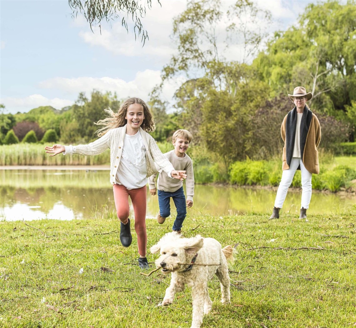 Family at pond with a dog