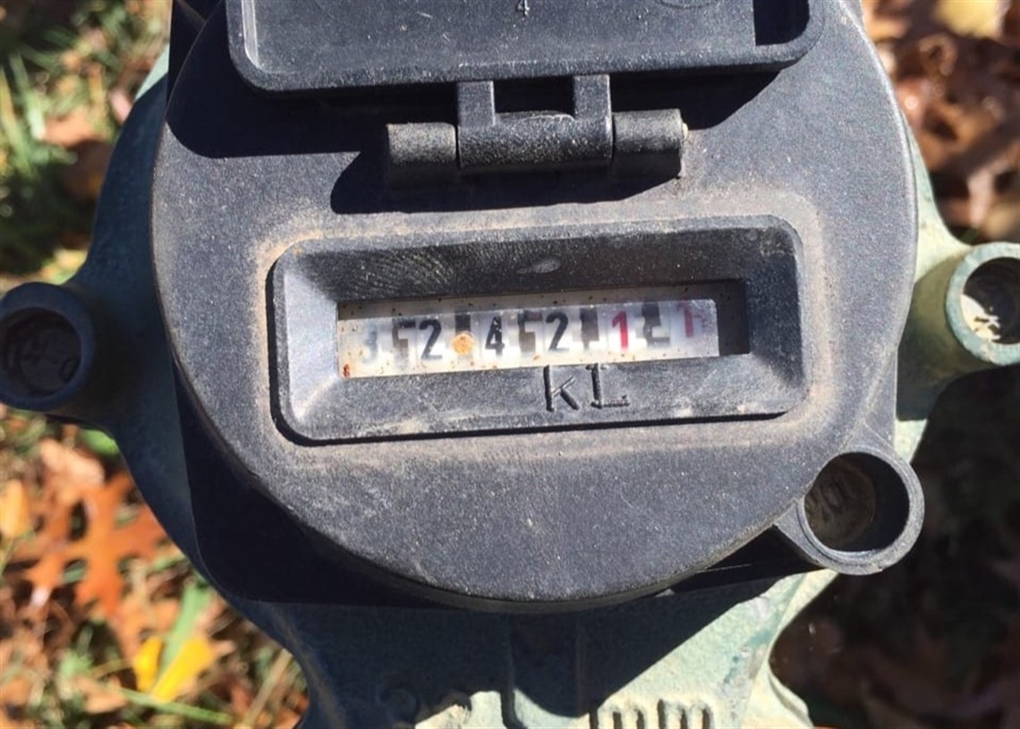 Up close photo of outdoor water meter reading