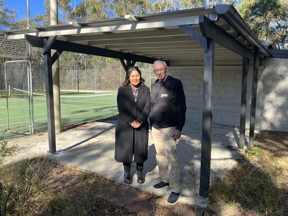 2 people standing in front of the wall at the park