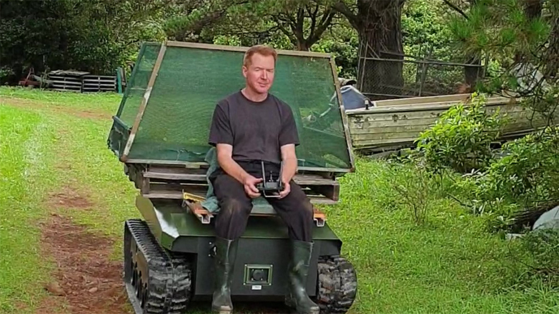 Man riding on a robotic mower