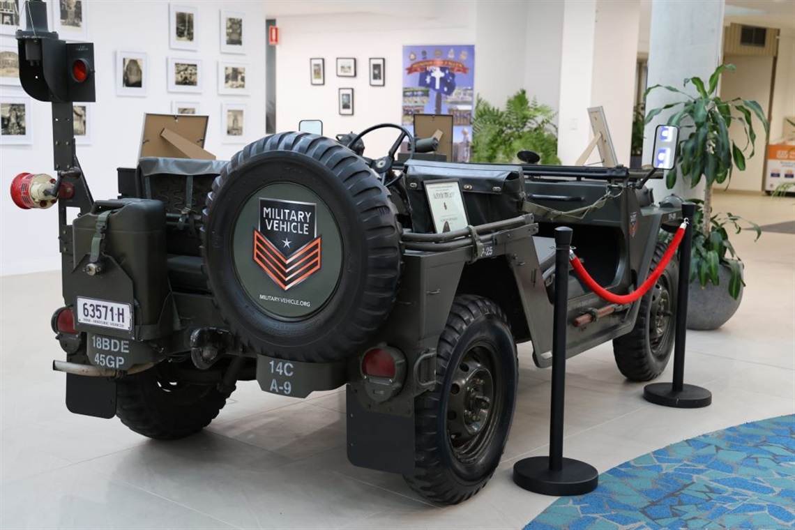 Photo of a Military Jeep Vehicle and other photos, artworks and war memorablilia at the Wingecarribee Remembers Atrium Exhibition May 2024 