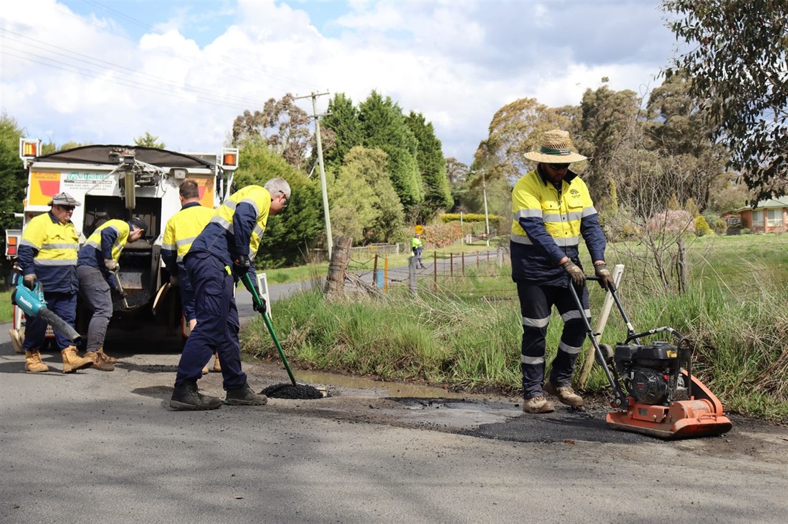 Council workman fixing a pothole