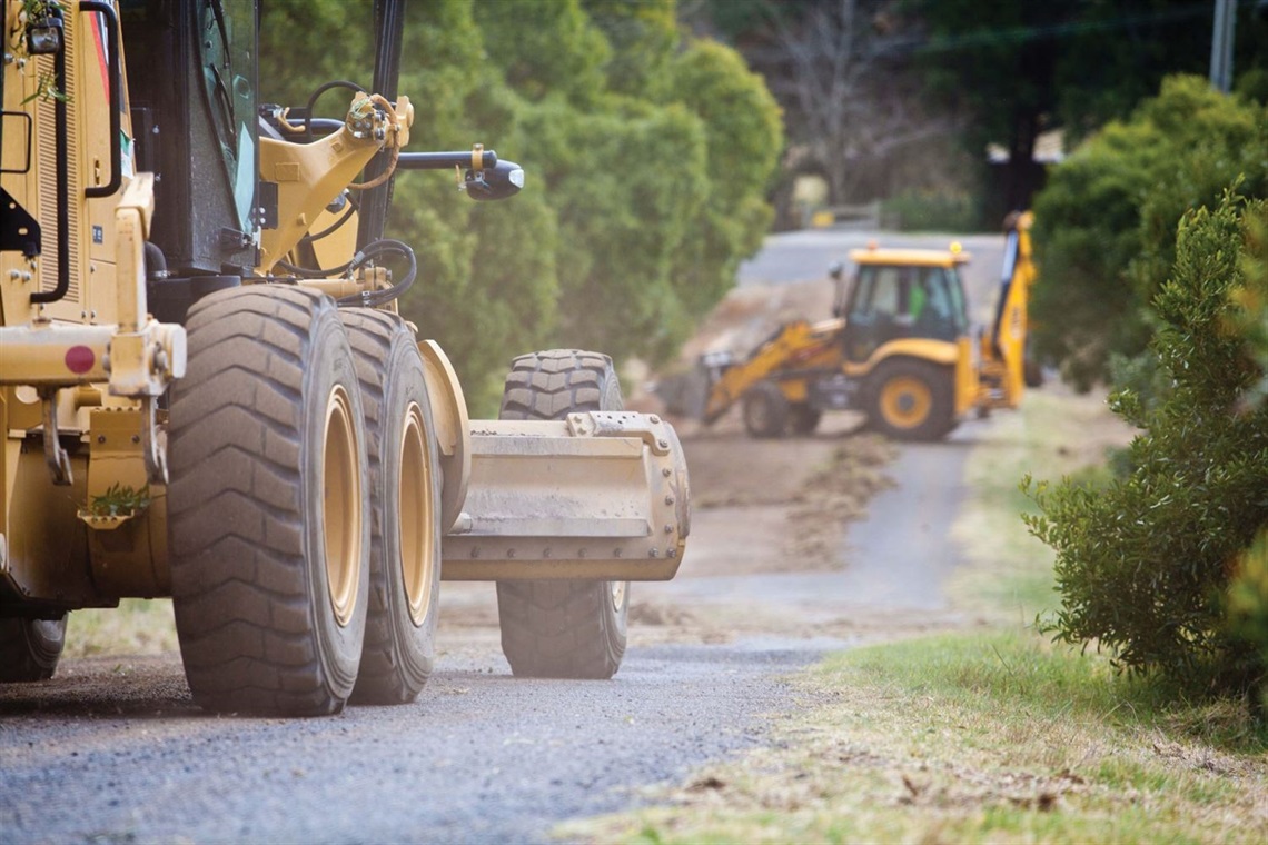 Two road graders working on sealed road