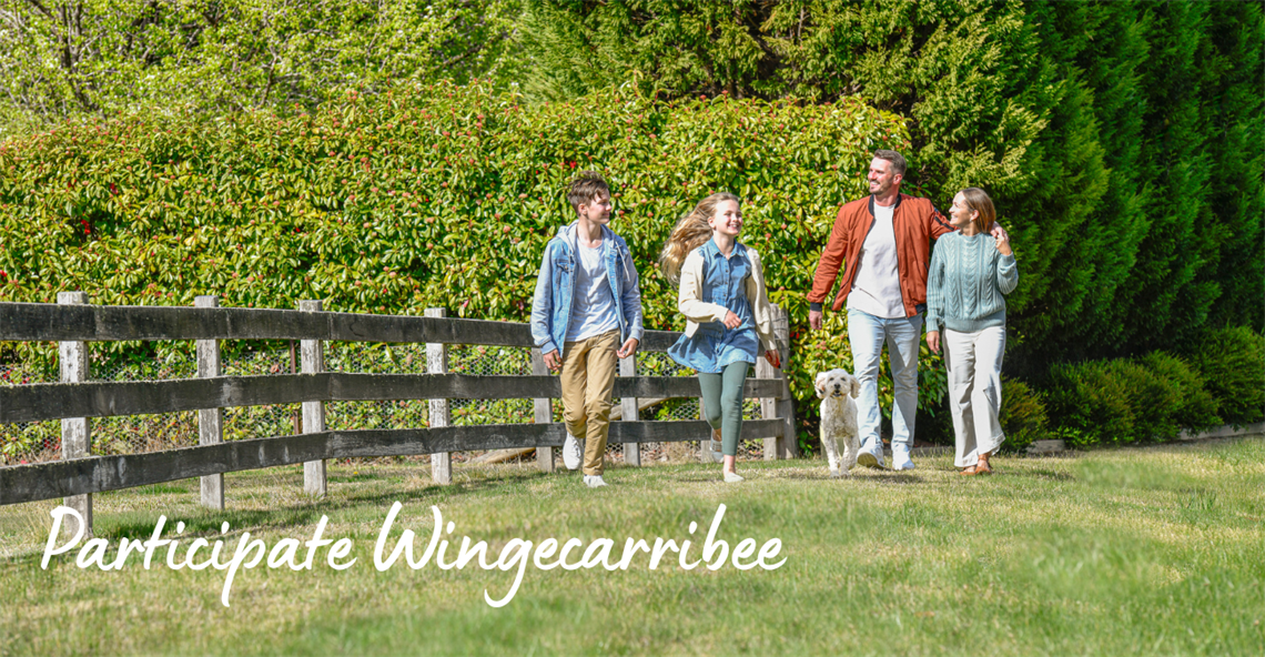 A family walking with their dog