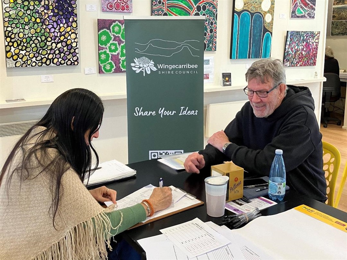 Arts and Culture one-on-one engagement with resident Council banner in background reads 'share your ideas'