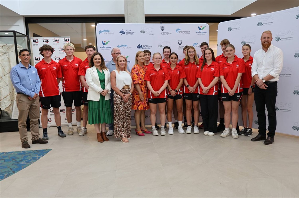 16 IAS scholarship recipients stand in Civic Centre Atrium following award ceremony