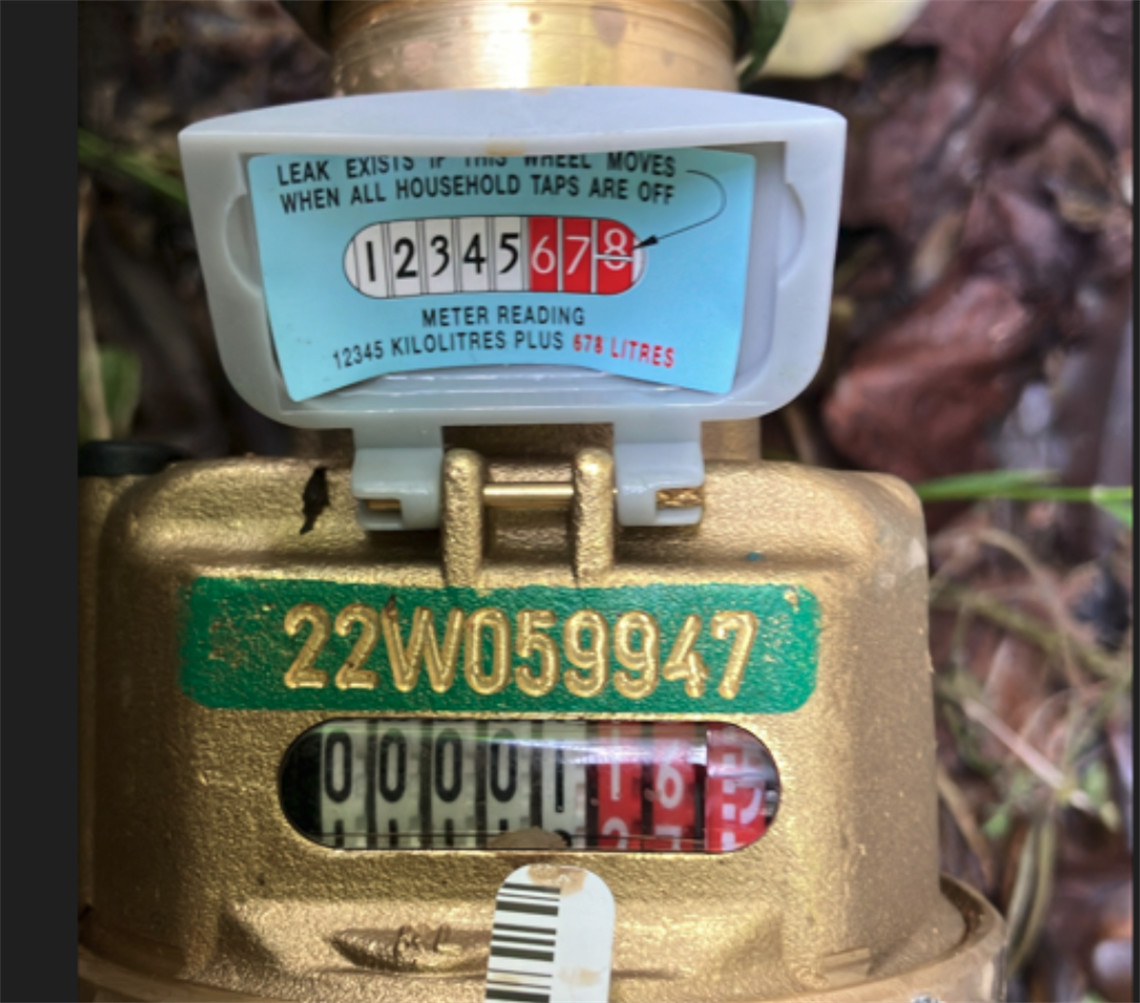 Close up photograph of a water meter with reading visible