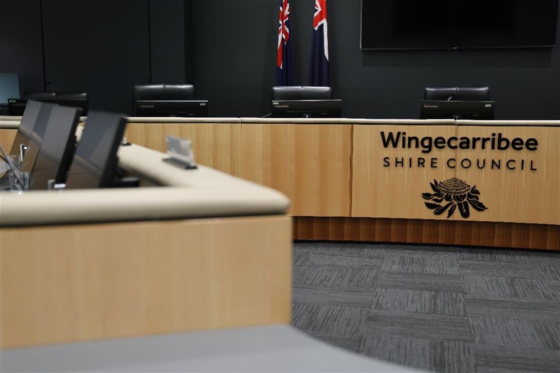 Empty Council Chambers Close up of Councillor and Mayoral/Executive desks with Wingecarribee Shire Council Logo