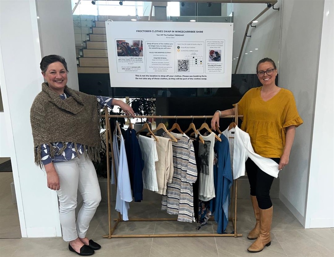 Council Environment Officers stand with a clothing rack that is part of Froctober display 