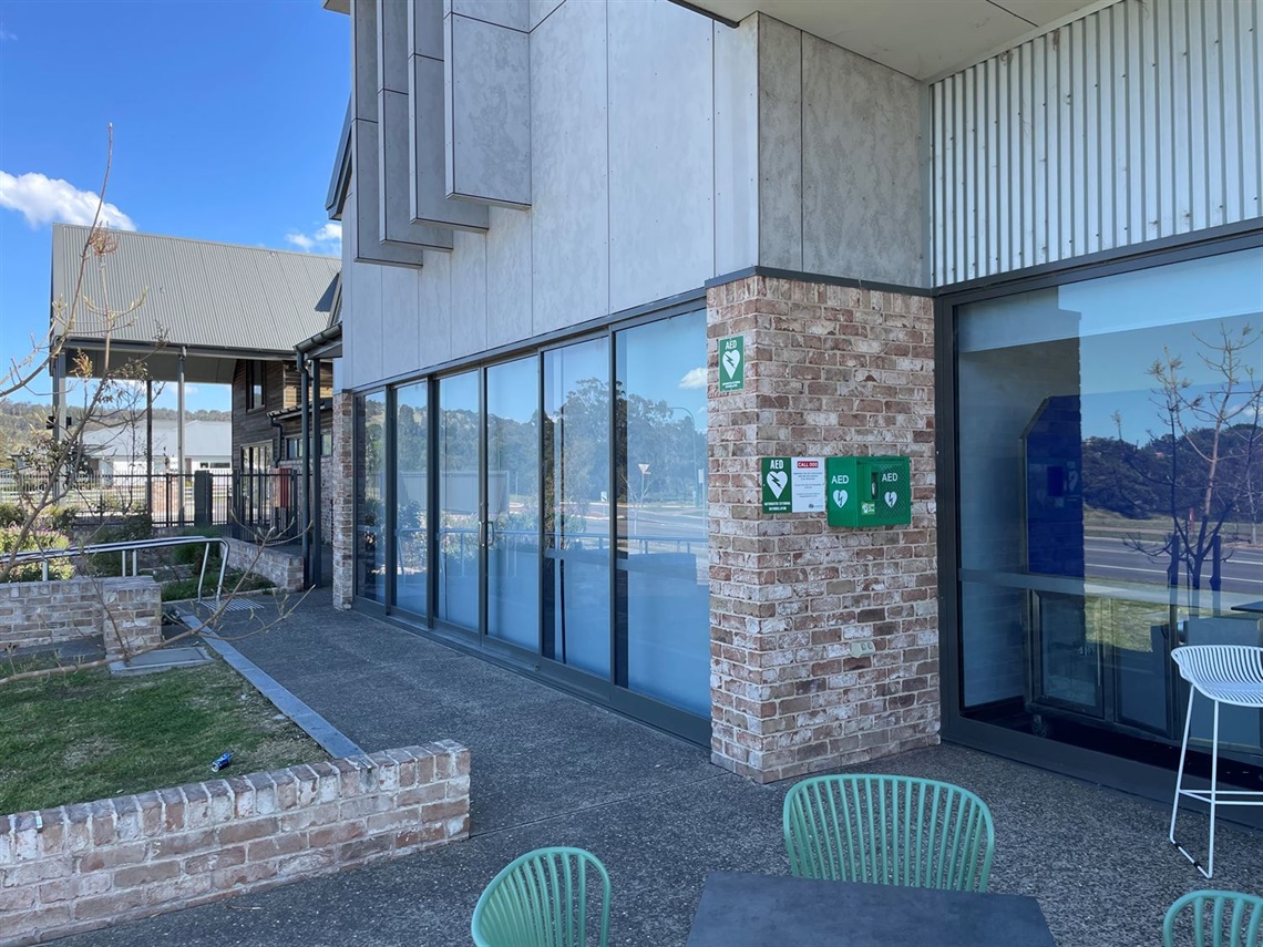 Public Defibrillator on brick wall of entry to Renwick Community Centre