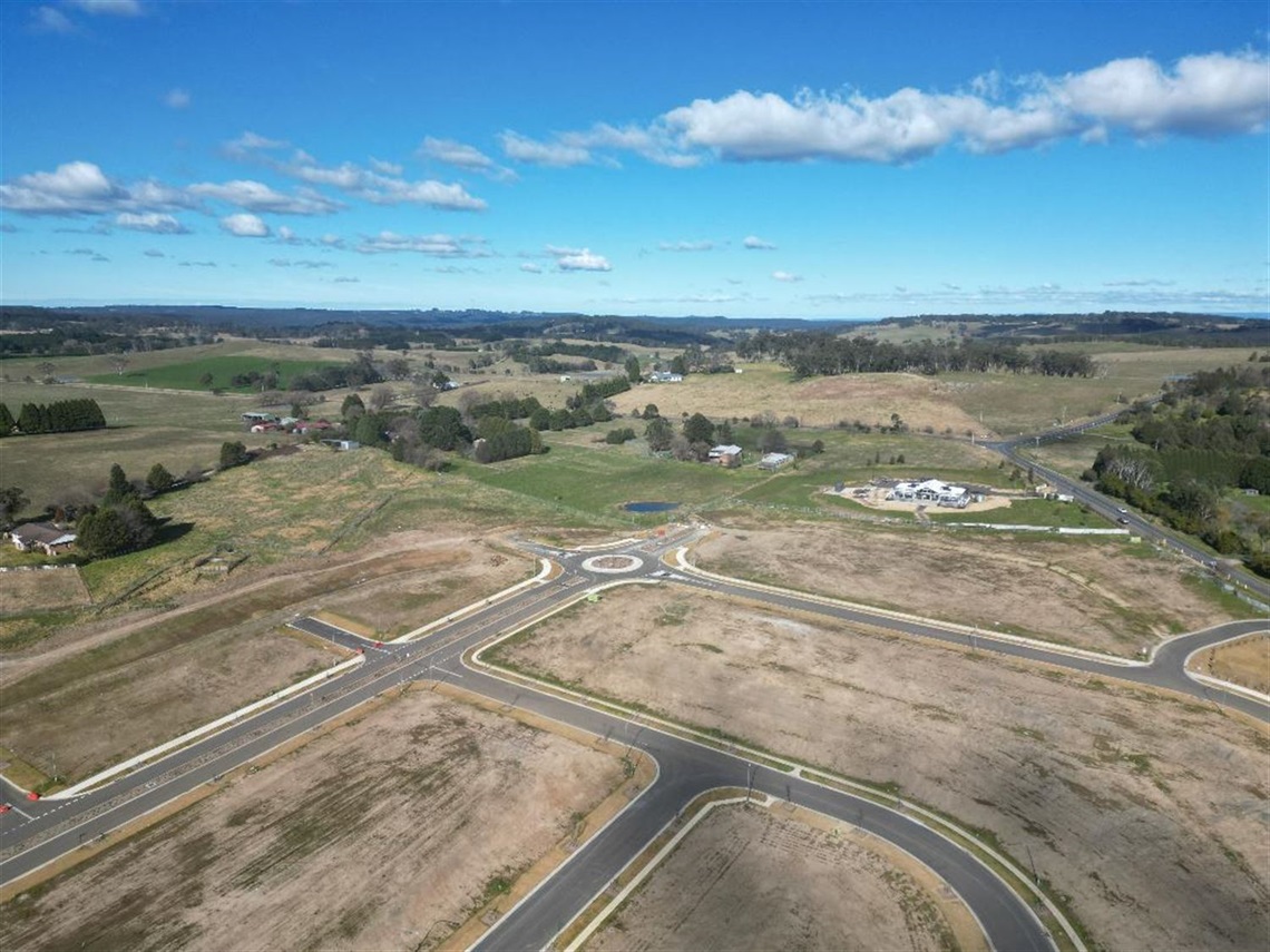 Drone Shot of vacant development with road infrastructure and farmland surrounds 