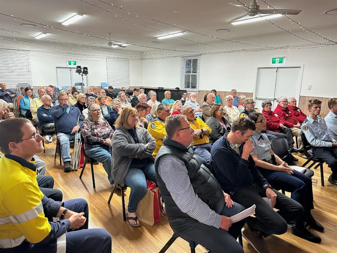 Group of community members watch presentation 