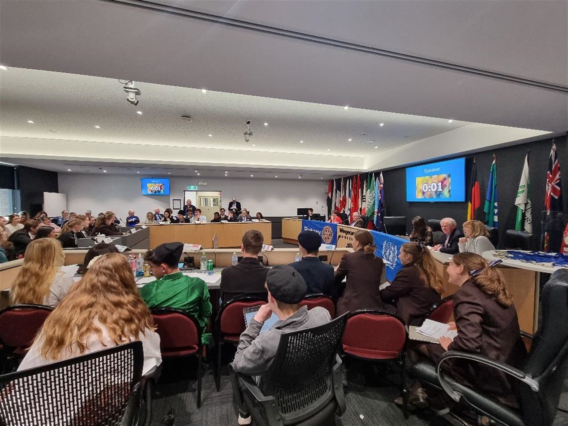 Students sitting in Council Chambers set up in UN Assembly formation